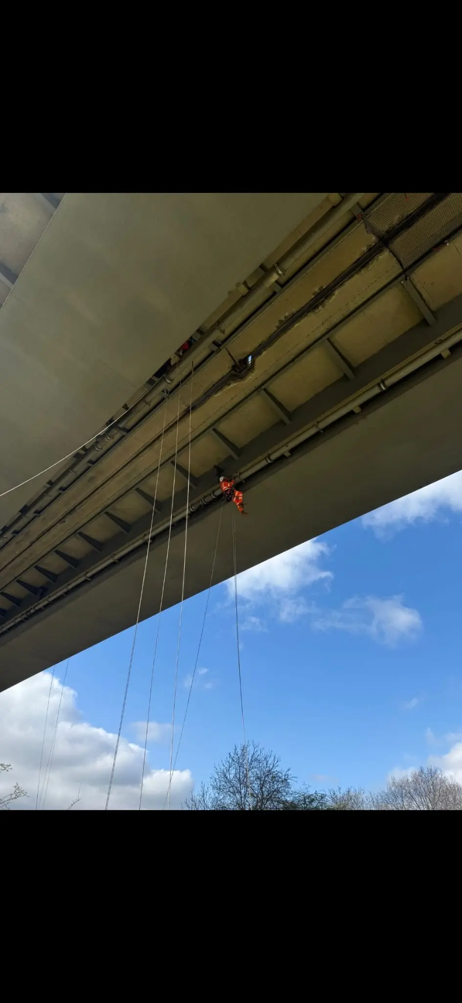 Rope access technician carrying out high-level maintenance